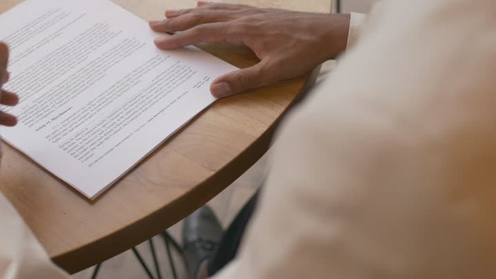 Hands reviewing a contract