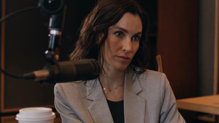 An interview at a studio microphone